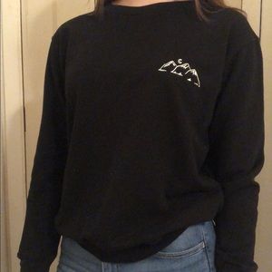 black sweater with mountain design